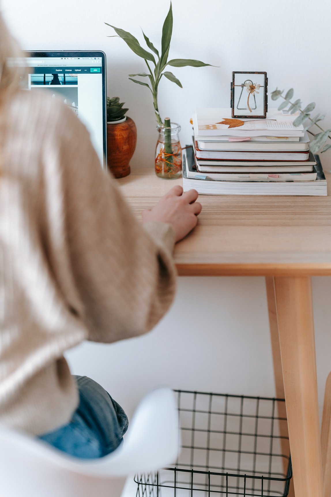 Unrecognizable freelancer working on laptop at home table