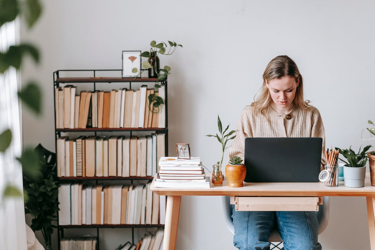 Concentrated freelancer working on laptop at home desk